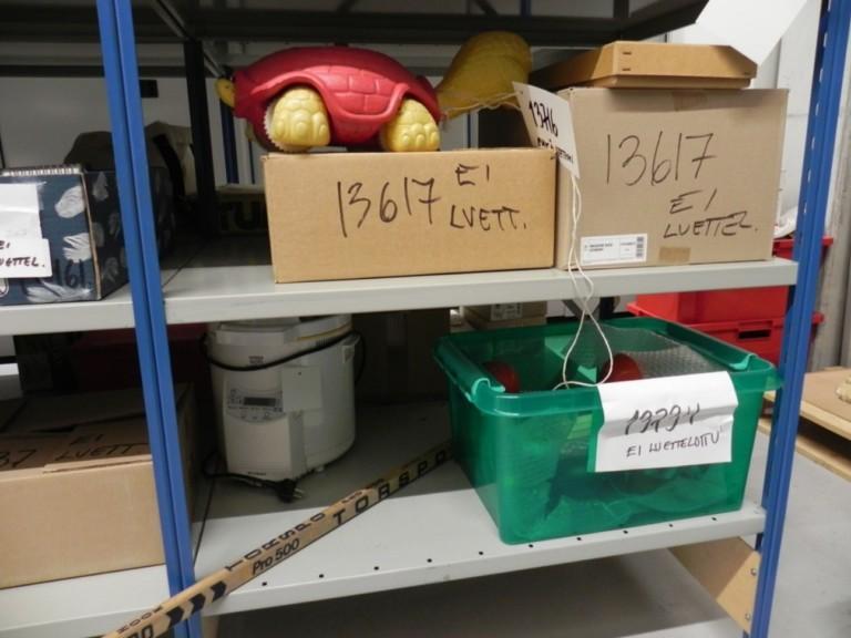 Monenlaista tavaraa varastohyllyllä.