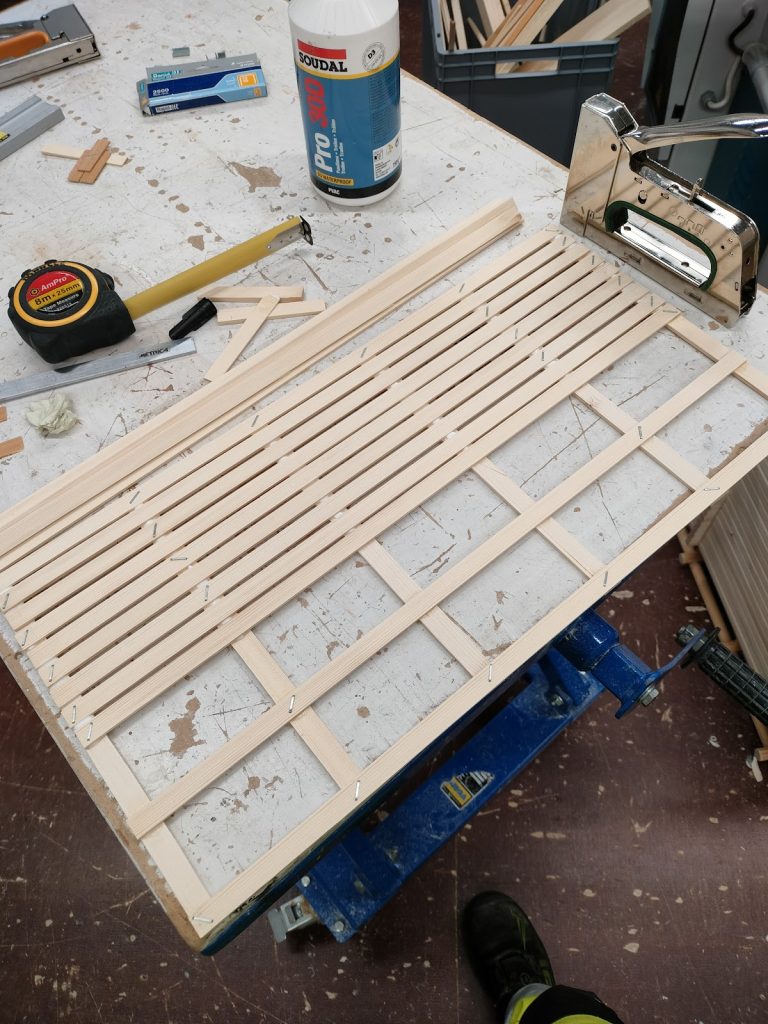 Puutikkuja aseteltuna rimaseinäksi.